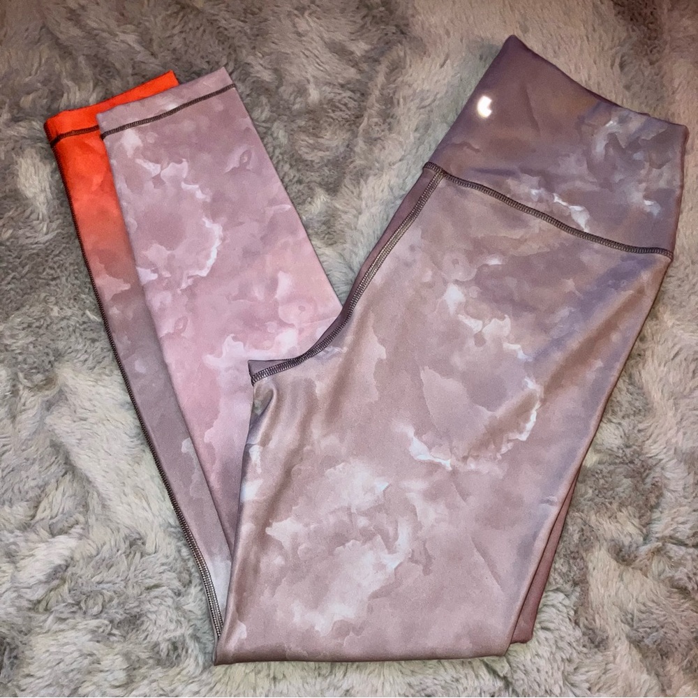 Lolë tights with a maybe burst pattern and sunset splash on ankle medium